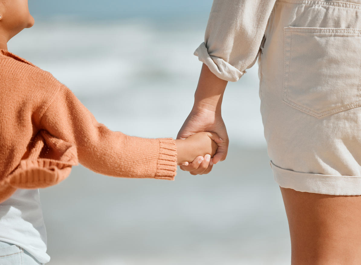 Mom holding childs hand