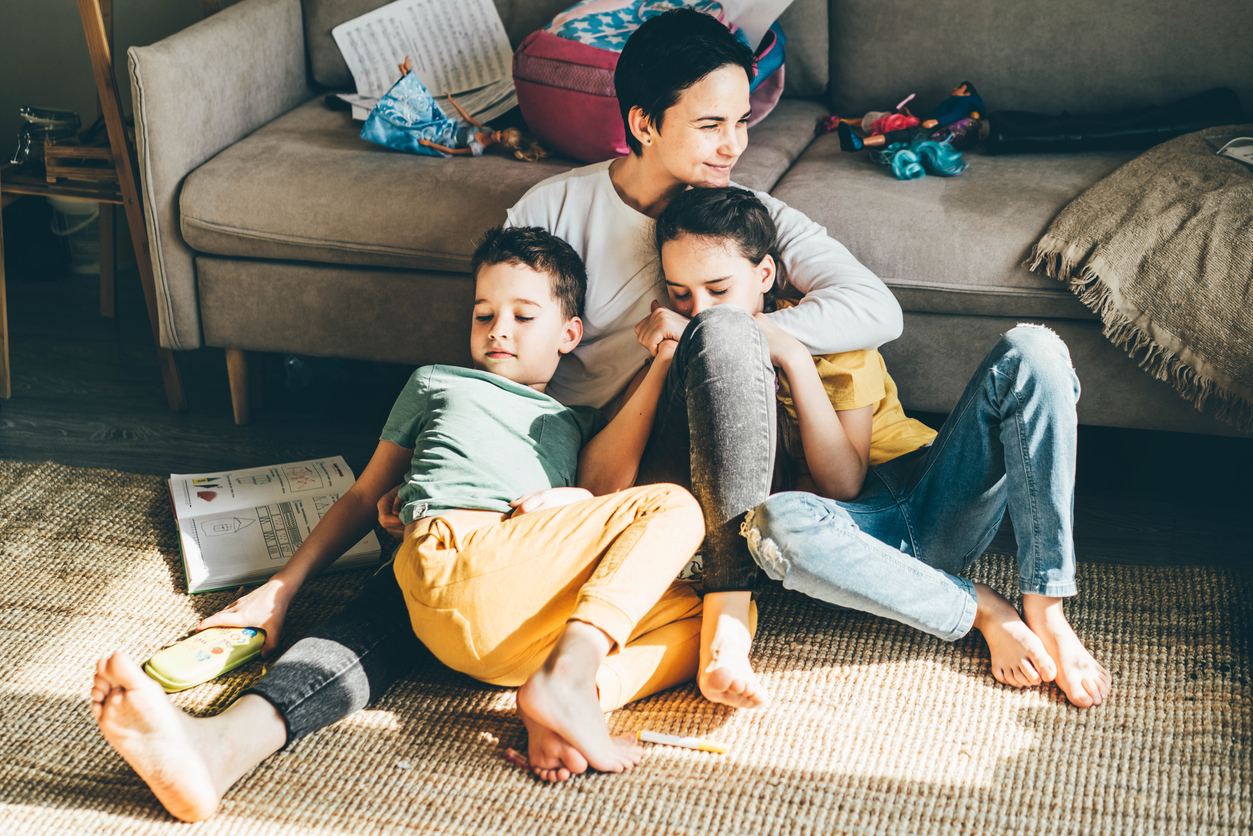 Mother with children on floor in home